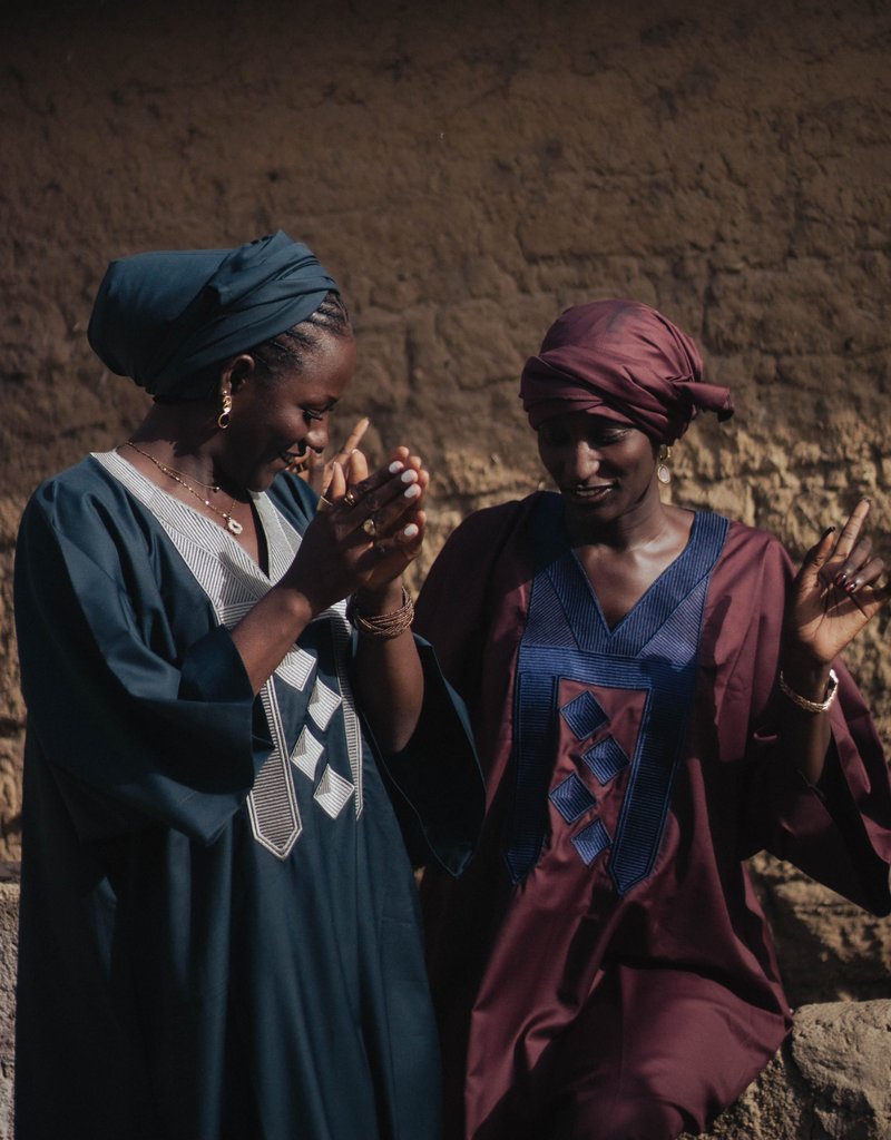 Friends sharing a joyful moment in traditional dress